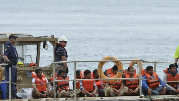 A boat load of asylum seekers arrive on Christmas Island.