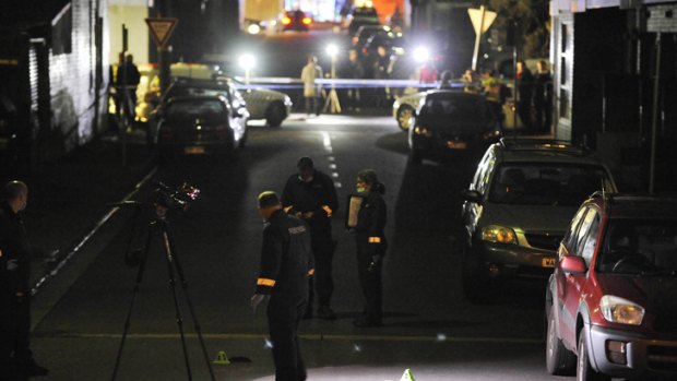 Police scan for evidence in Florence Street, Brunswick after two men were shot dead in a panel-beating shop.