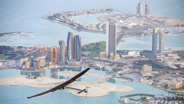 The solar-powered plane Solar Impulse 2 flies over the Emirati capital Abu Dhabi during its third successful test flight in the United Arab Emirates on Monday. 
