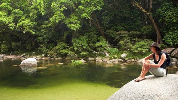 Tranquillity ... a visitor soaks up the silence at Mossman Gorge.