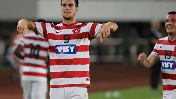 Victorious in defeat: Tomi Juric celebrates his goal against Guangzhou Evergrande.