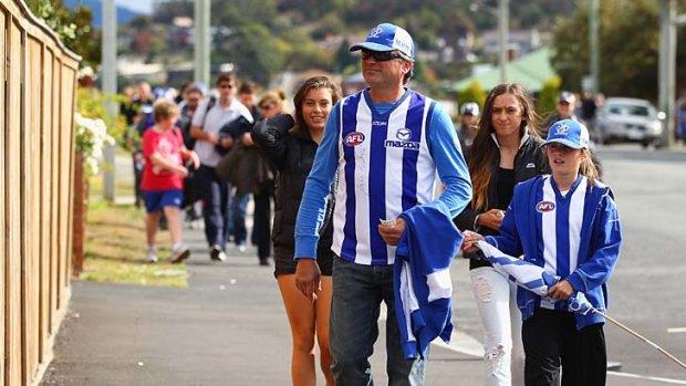 Fans arrive prior to the round two AFL match between the North Melbourne Kangaroos and the Greater Western Sydney Giants at Blundstone Arena.