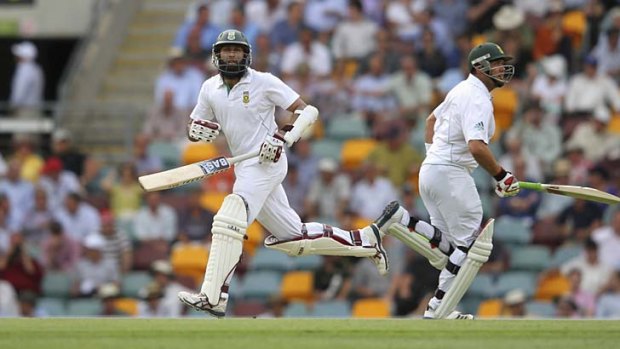 Two up ... Hashim Amla and Jacques Kallis cross for another run on their way to 90 and 84 respectively, as Ricky Ponting looks on during day one of the first Test at the Gabba.
