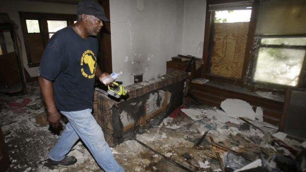 Calvin Brooks, a member of Black on Black Crime, a community group which holds rallies and is heavily involved in neighborhoods, searches a home in East Cleveland, Ohio.