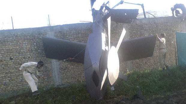 Part of a damaged helicopter  near the compound after the SEAL raid.