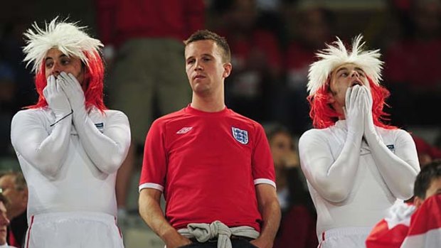 England fans at the ground look dejected after suffering defeat.