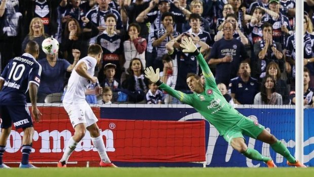 On target: Leigh Broxham slots Victory's third goal past Ante Covic on Friday night.