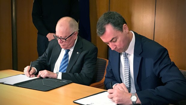 Federal justice minister Michael Keenan and ACT police minister Mick Gentleman signed the Policing Arrangement Memorandum of Understanding in Canberra on Thursday, June 15.