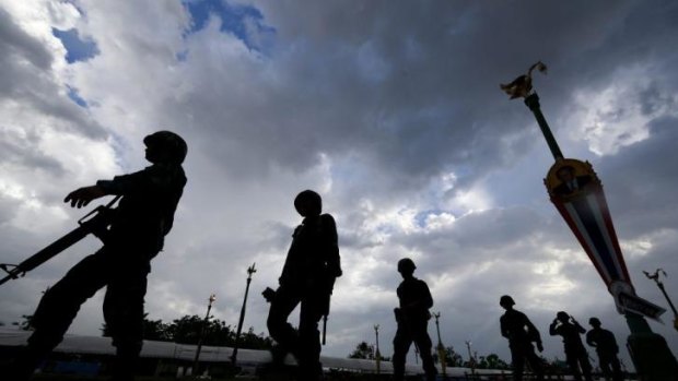 Thai soldiers patrol after a clean-up operation at a pro-government demonstration site on the outskirts of Bangkok.