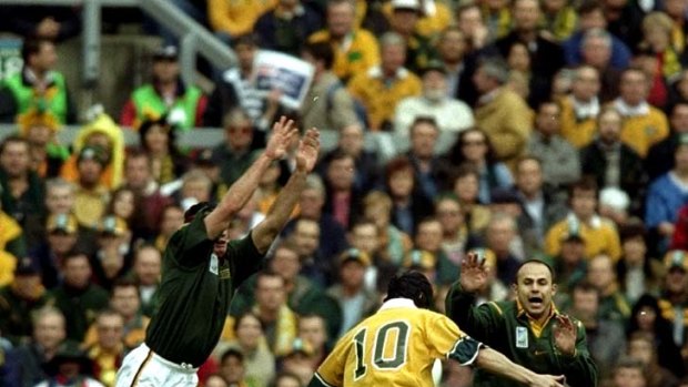 Drop goals are important ... the Springboks attempt to charge down Stephen Larkham's 40m drop-goal during the semi-final of the 1999 World Cup.