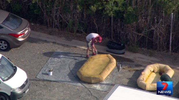 A production crew member inflates a liferaft on the set of Angelina Jolie's new movie. Photo: Seven News.