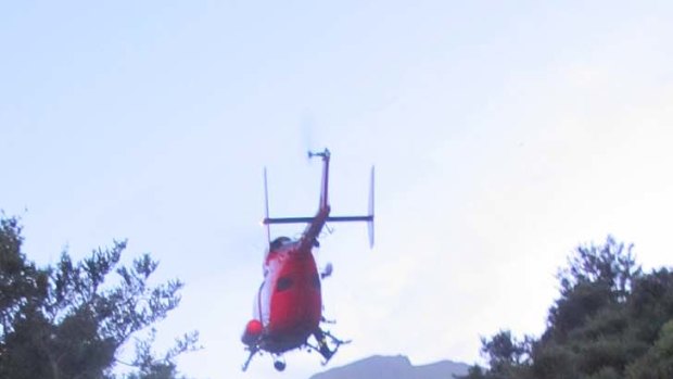 A rescue helicopter lifts Dion out of the gorge.