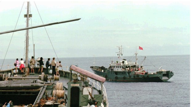 A Chinese vessel, right, with the markings "China Fishing Administration 34" blocks the path of a Philippine Navy ship MV Benguet while some Filipino and foreign journalists are being ferried to the Mischief Reef in May 1995.  It was the first physical confrontation between China and the Philippines in the disputed group of islands.