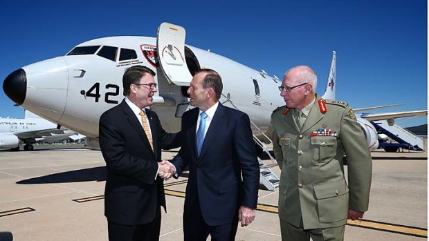 US ambassador to Australia, John Berry, Prime Minister Tony Abbott and Chief of the Defence Force General David Hurley, inspect the P-8A Poseidon aircraft, at Fairbairn RAAF base in Canberra on Friday 21.