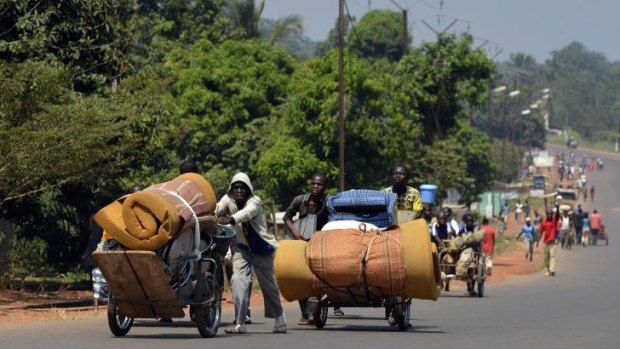Refugee crisis: Residents of the capital, Bangui, leave with their belongings on Friday.