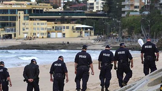 Police search the beach for clues.