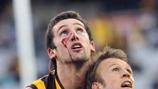 Hawk Brent Renouf (left) and Port?s Dean Brogan do battle at the MCG yesterday.