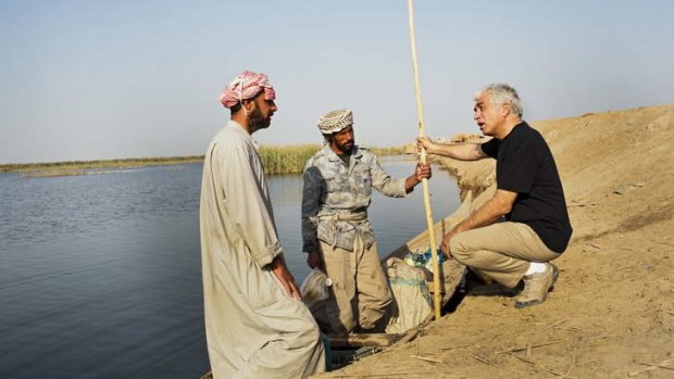Flow on effect: Azzam Alwash speaks with a fish seller in Kirmashiye's central marshes in 2012. After 10 years of restoration efforts, the marshes are back to more than 50 per cent of their original size.