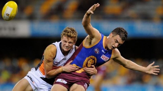 Will Hoskin-Elliott of the Giants tackles Tom Rockliff of the Lions during the round 13  match on Saturday.