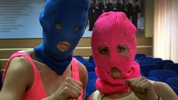 Wearing masks, Nadezhda Tolokonnikova and Maria Alyokhina pose for a photo in a police station after their arrest.