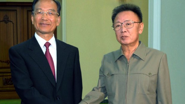 Shaking on it . . . China's Wen Jiabao with Kim Jong-Il.