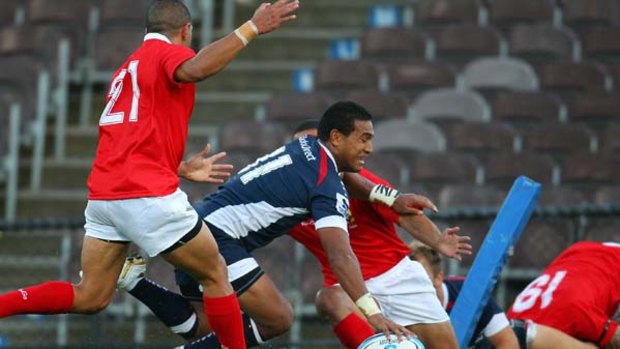 Former rugby league star Cooper Vuna scores for the Rebels.