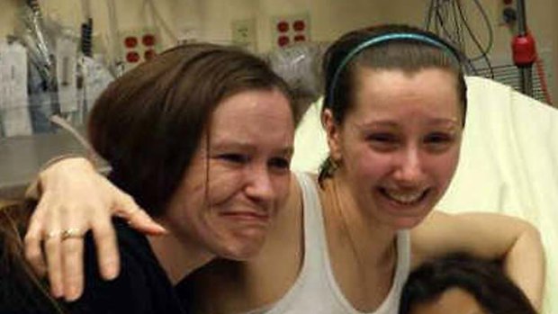 Free at last: Amanda Berry (with headband) is reunited with her sister following her escape.