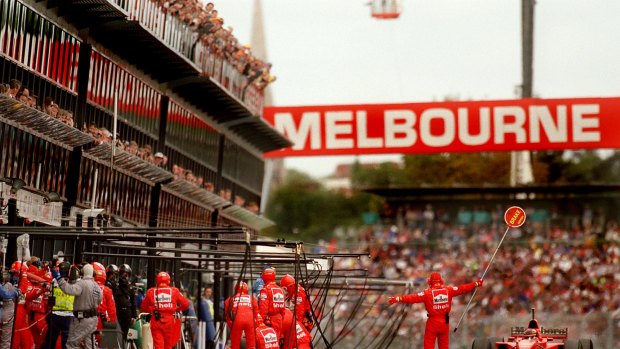Spectators hang off the stands to watch as Michael Schumacher pulls into the pits for fuel at the 1997 Australian Grand Prix, Melbourne,