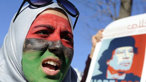 A woman with her face painted in the colours of the Libyan flag joins a demonstration against Muammar Gaddafi in front of the White House in Washington.