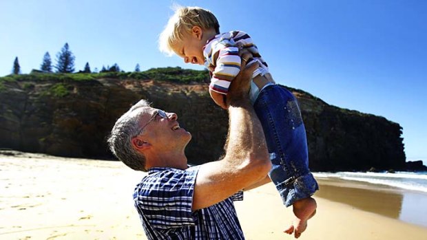 Bewildered: Newcastle dentist Andreas Schwander with his son Philip at Redhead Beach.