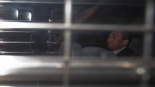 Behind bars: Peter Chan sits in a prison van as he leaves court.