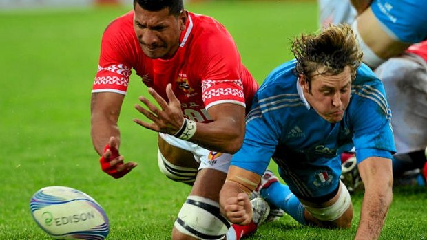 Tight tussle ... Tonga's flanker Sitiveni Mafi fights for the ball with Italy's lock Joshua Furno.