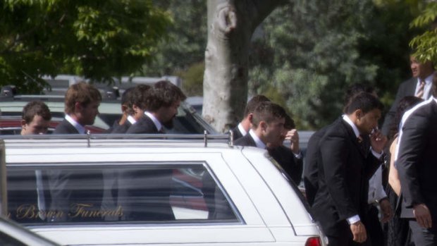 Wests Tigers players and staff enter the funeral of Mosese Fotuaika, held in Cleveland, east of Brisbane.