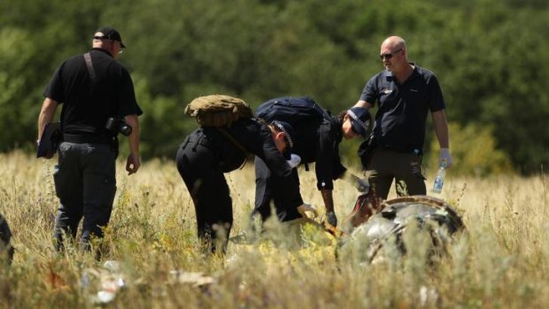 Australian Federal Police search at the MH17 crash site for human remains.
