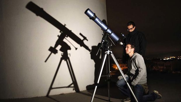 Students of the Astronomical Association of Sabadell prepare to watch Asteroid 2012 DA14 pass Earth, in Sabadell, Spain.