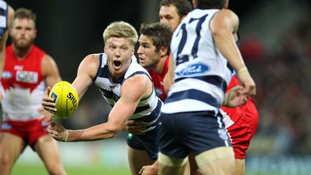 Geelong's George Horlin-Smith fires out a handball against the Swans on Friday night.