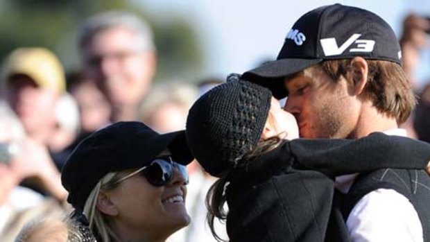 First US Tour title in four years ... Aaron Baddeley celebrates with his family.