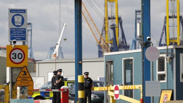 Police stand guard at an entrance to Tilbury Docks.