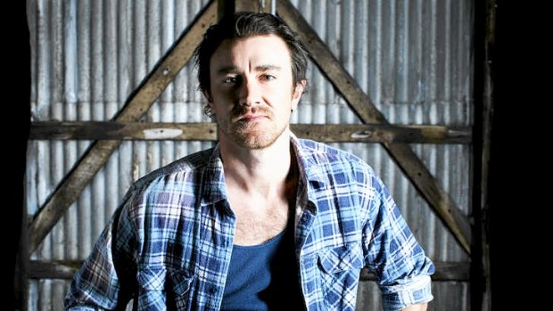 Actor Josh McConville teams the Aussie bogan staples, a flannelette shirt with a navy Bonds singlet.