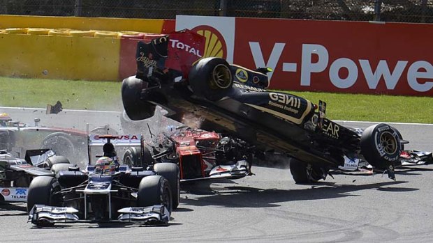 Lotus Formula One driver Romain Grosjean (right) crashes at the start of the Belgian Grand Prix.