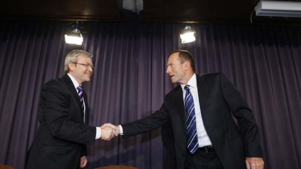 Prime Minister Kevin Rudd greets Opposition Leader Tony Abbott prior to the debate at the National Press Club in Canberra. Photo by Andrew Meares