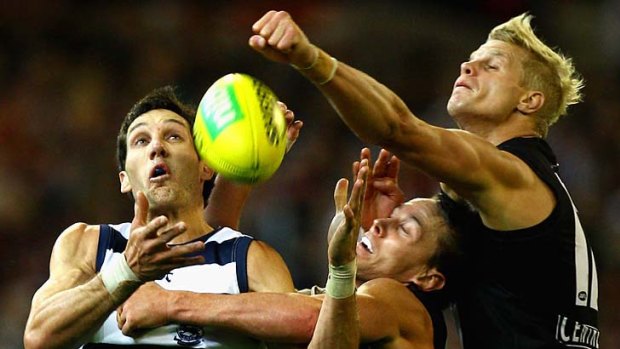 Fist of fury: St Kilda's Nick Riewoldt (right) attempts to spoil Geelong's Harry Taylor at the MCG on Friday night.