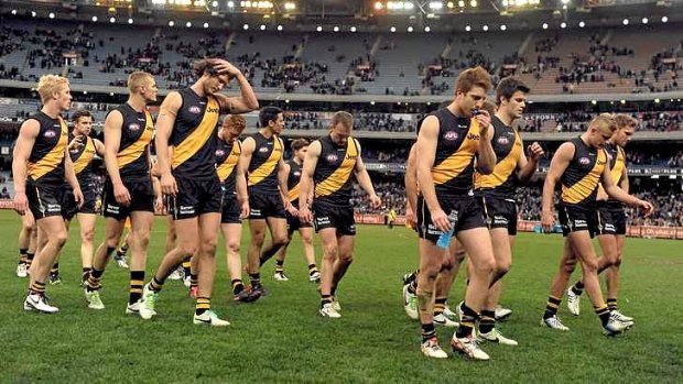 Richmond players walk off after losing to Carlton.