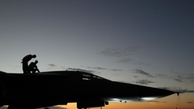 Crowd favourite ... Air Force crew prepare an F-111 for its last major international exercise yesterday.