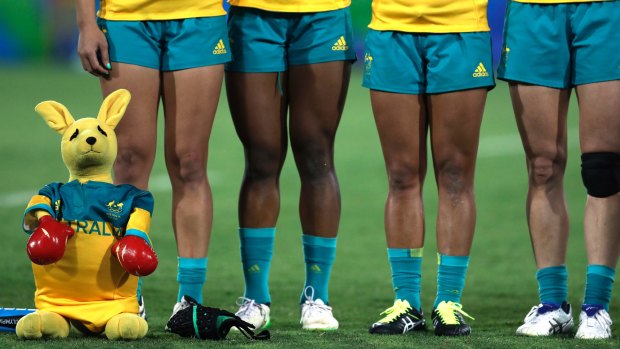 Australia's players line up for the singing of the national anthem during the women's rugby sevens gold medal match against at the Summer Olympics in Rio de Janeiro.