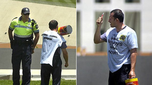 Marat Aminov threatens to set himself on fire outside Parliament House yesterday, as captured by the Canberra Times.