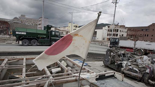 A Japanese flag flies over the remains of the town of Onagawa.
