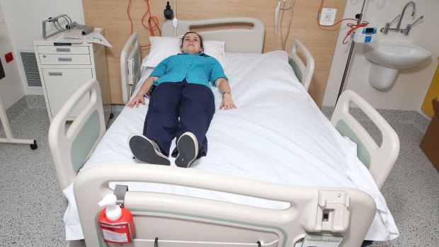 Rebecca Donnelly demonstrates one of the larger beds available at Campbelltown Hospital.