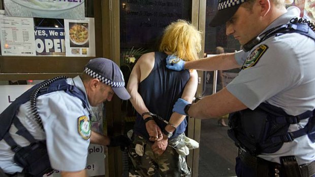 Police deal with an intoxicated male suspected of criminal activity in Kings Cross.