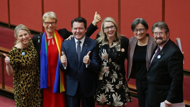 Senators Louise Pratt, Janet Rice, Dean Smith, Skye Kakoschke-Moore, Penny Wong and Derryn Hinch celebrate the passing of the marriage equality bill in the Senate.